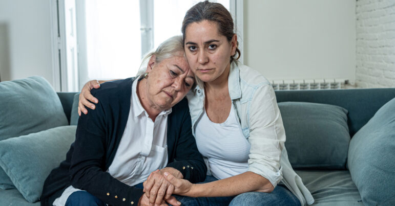 A daughter comforts her sad mother