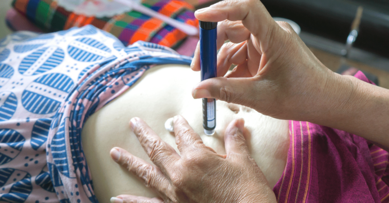 Woman injecting insulin